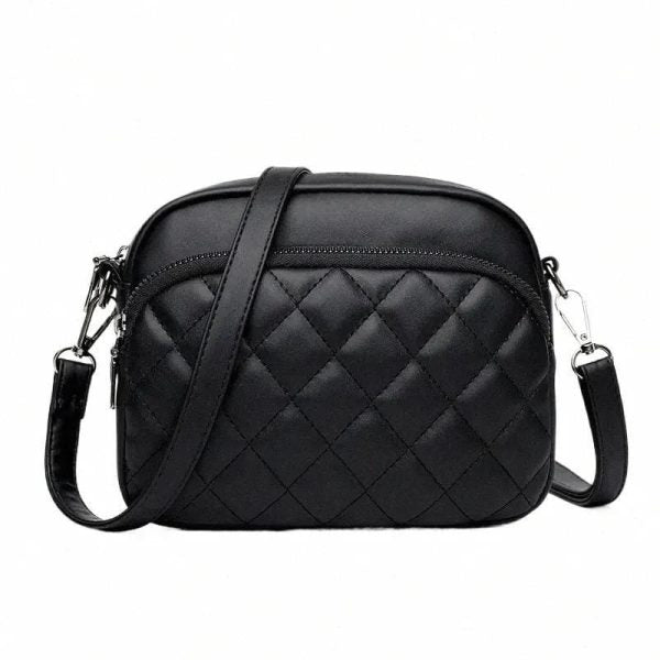 Black quilted handbag with a strap on a white background