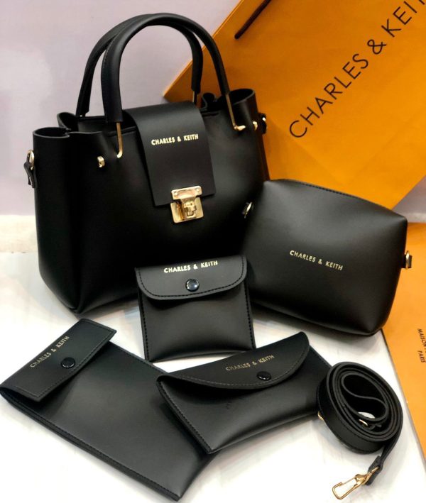 Black handbag set with matching pouches and wallet on a white background with 'Charles & Keith' branding.