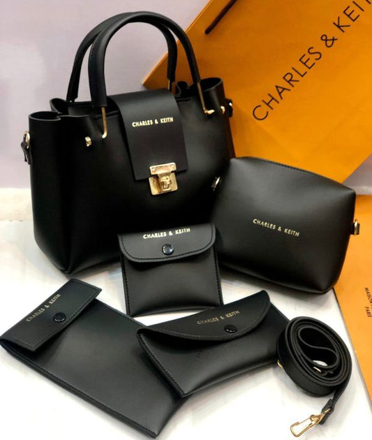 Black handbag set with matching pouches and wallet on a white background with 'Charles & Keith' branding.