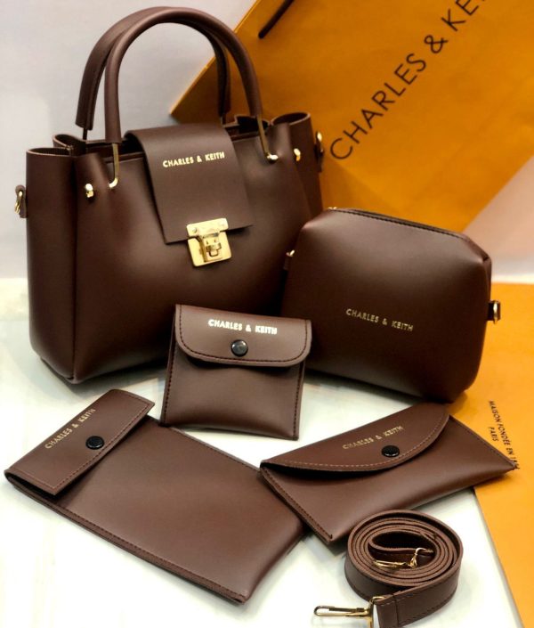 Brown handbag set with matching pouches and wallet on a white background