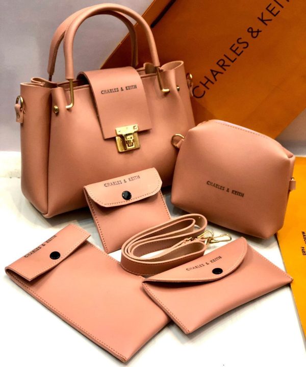 Set of pink handbags and accessories with 'CHARLES & KEITH' branding on a white background.