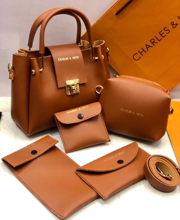 Brown leather handbag set with matching wallet, pouch, and belt on a white background.