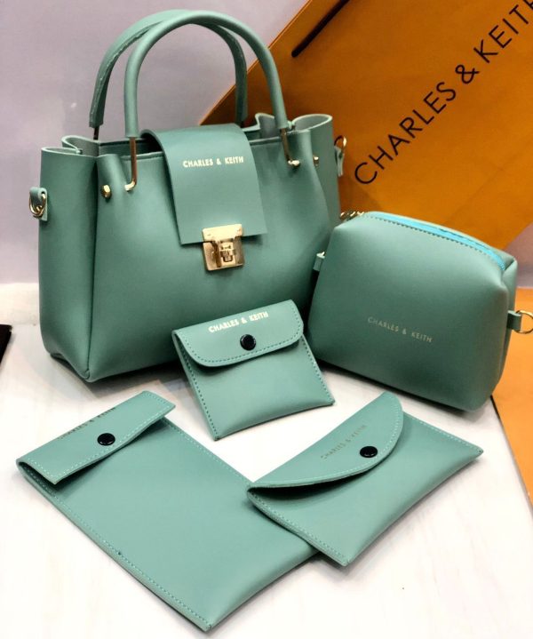 Set of green handbags and wallets with 'Charles & Keith' branding on a white background.