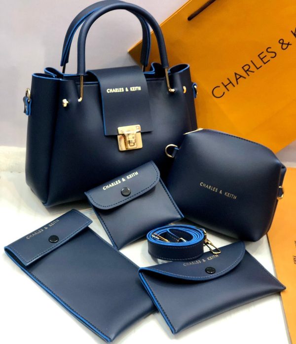 Blue handbag set with accessories on a white background